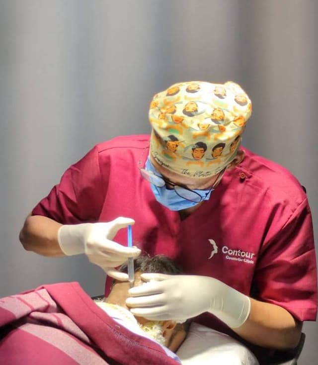 Dr Saket Performing Hair Transplant OT image